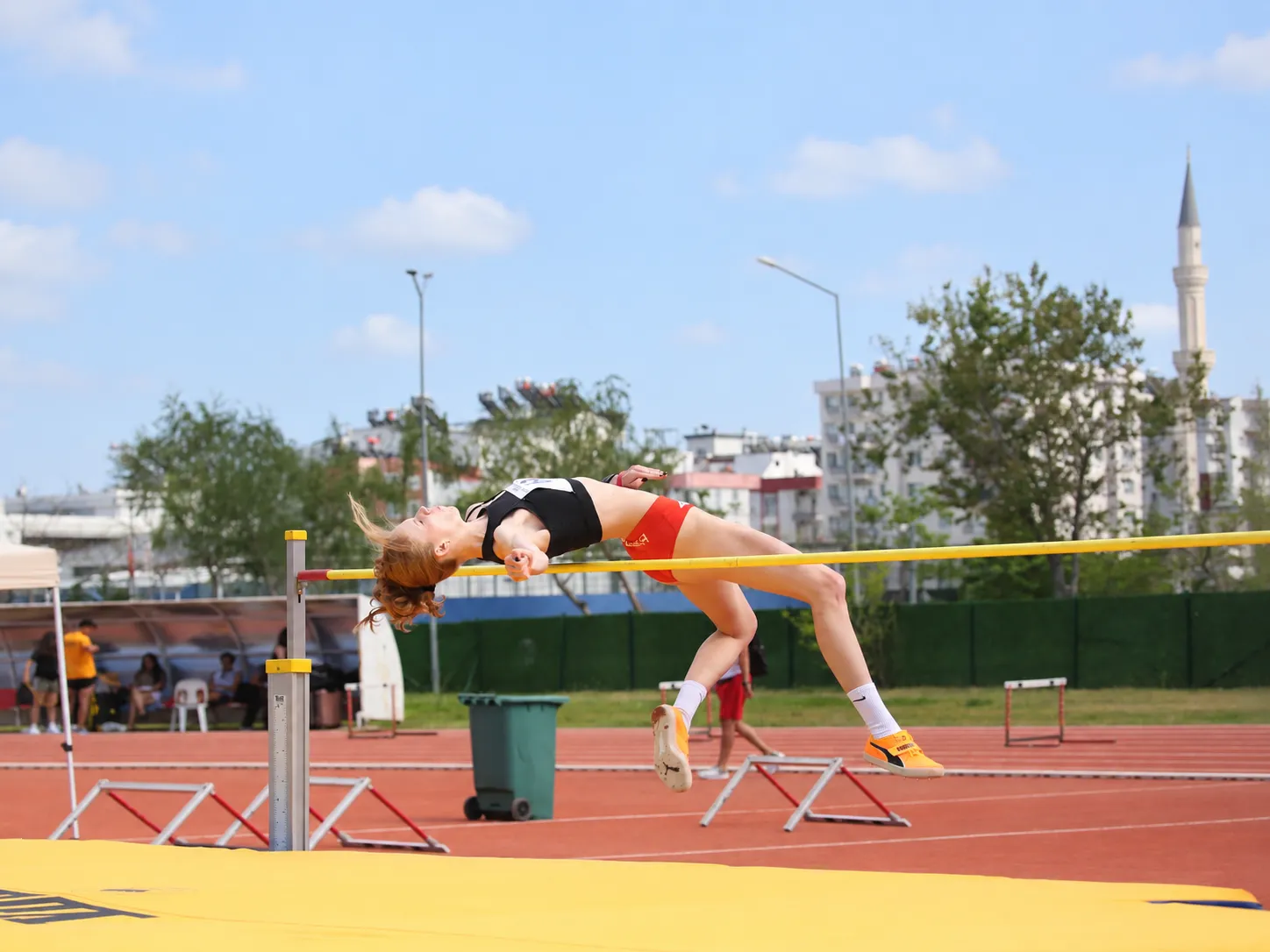 High jumper clearing the bar at the stadium
