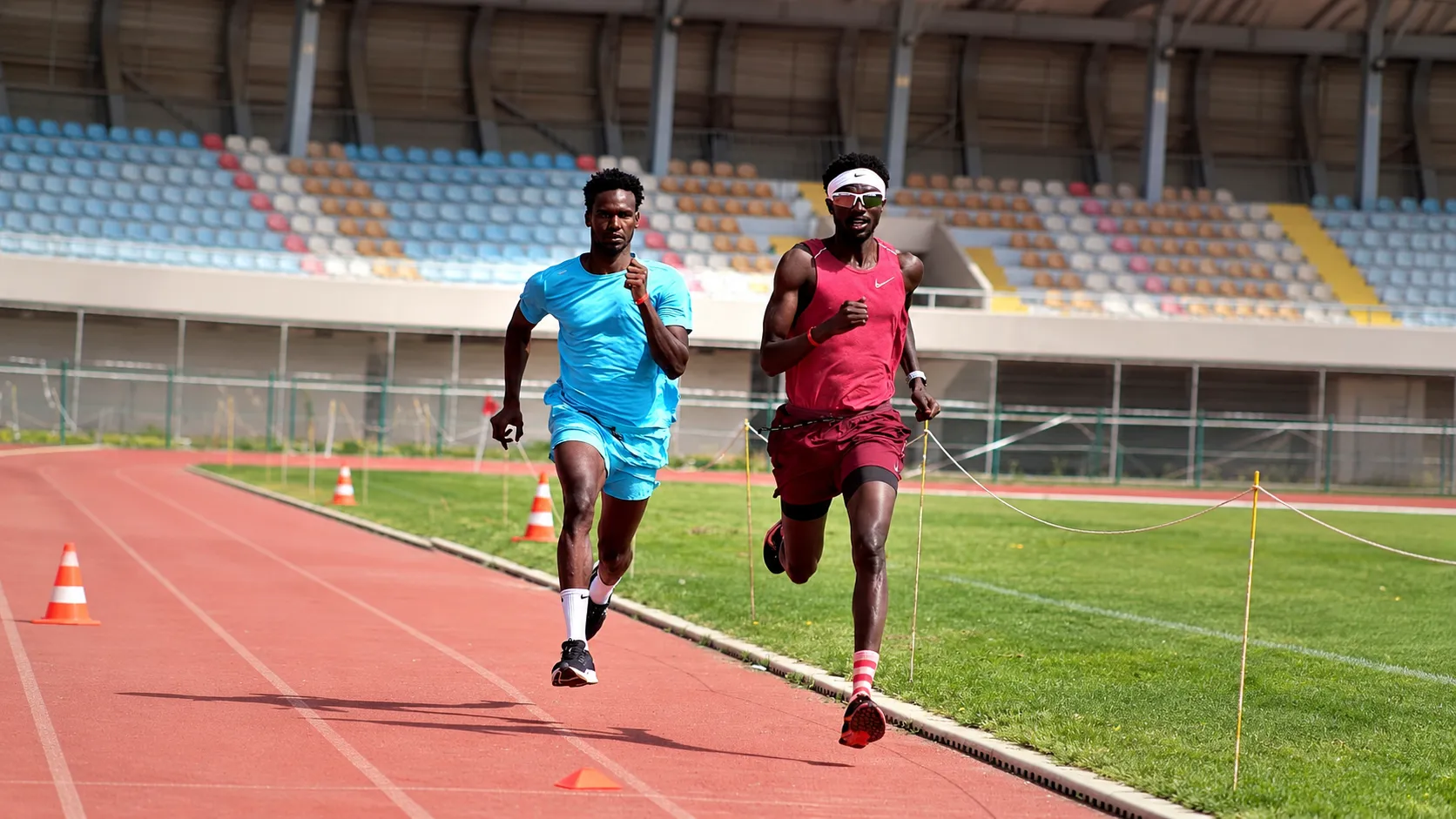 Two sprinters running side by side on the track